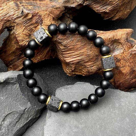 Volcanic stone bracelet, enhances energy and safeguards balance.